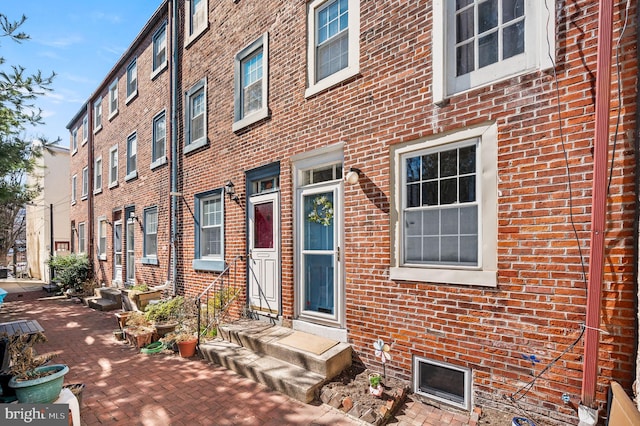 entrance to property with brick siding