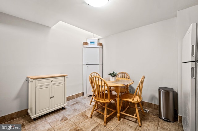 dining area featuring baseboards