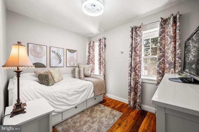 bedroom featuring dark wood finished floors and baseboards