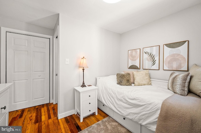 bedroom featuring baseboards and wood finished floors