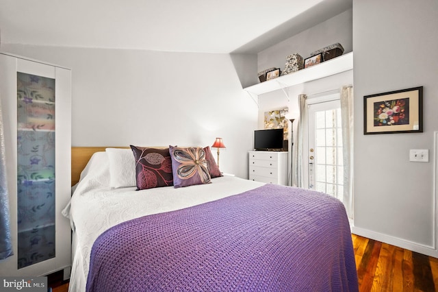 bedroom featuring baseboards and wood finished floors