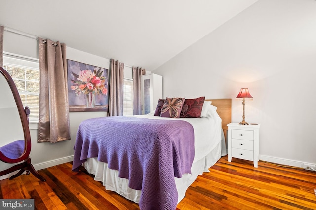 bedroom featuring vaulted ceiling, wood finished floors, and baseboards