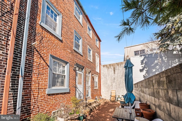 view of property exterior with brick siding