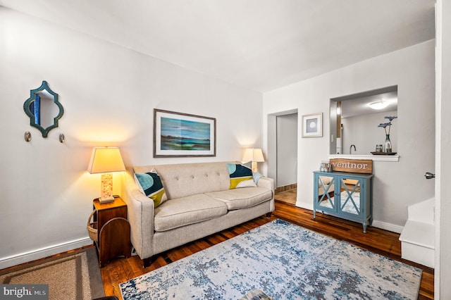 living area featuring baseboards and wood finished floors