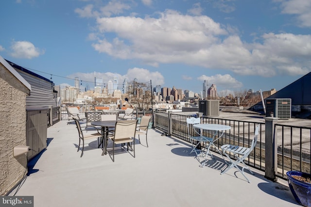 view of patio / terrace with a view of city and outdoor dining space