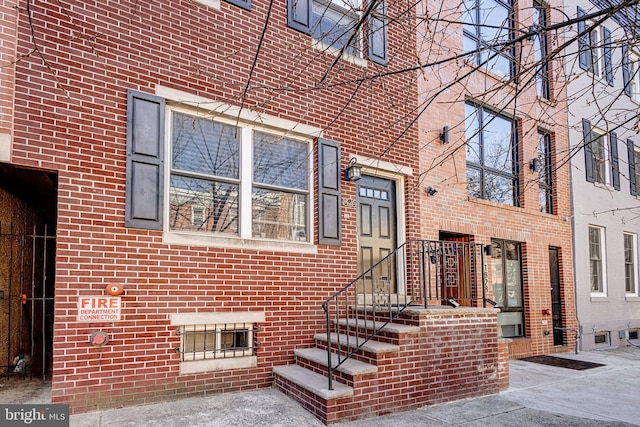 doorway to property with brick siding