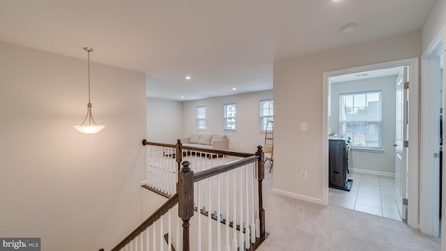 hallway with recessed lighting, light colored carpet, light tile patterned flooring, an upstairs landing, and baseboards