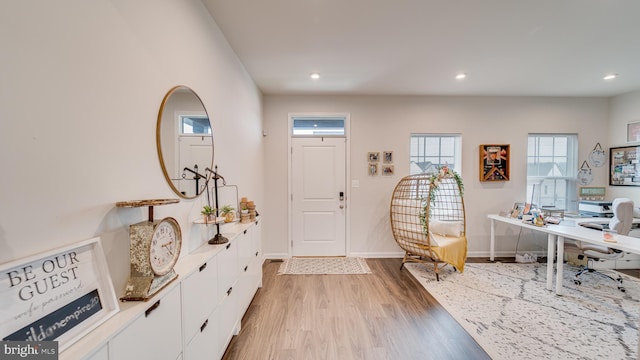 foyer featuring baseboards, recessed lighting, and light wood-style floors