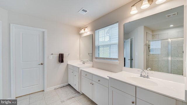 full bathroom with visible vents, a sink, a shower stall, and tile patterned floors