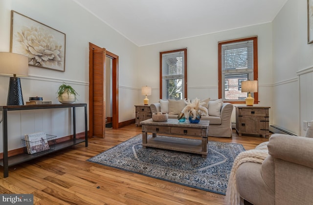 23 Swan St, Lambertville, NJ 08530 - living area with baseboard heating, wood finished floors, and wainscoting