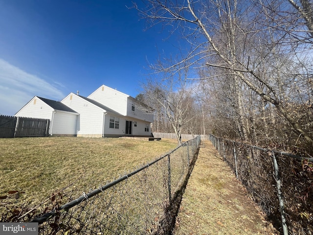 view of property exterior with a fenced backyard and a lawn