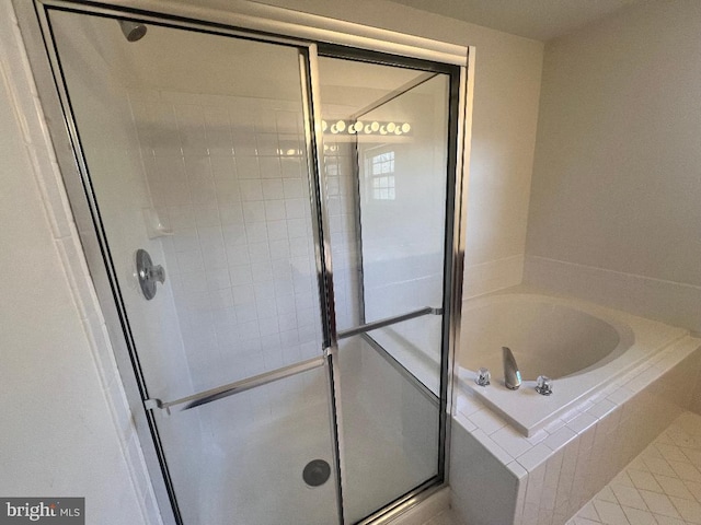 bathroom with a stall shower and a bath