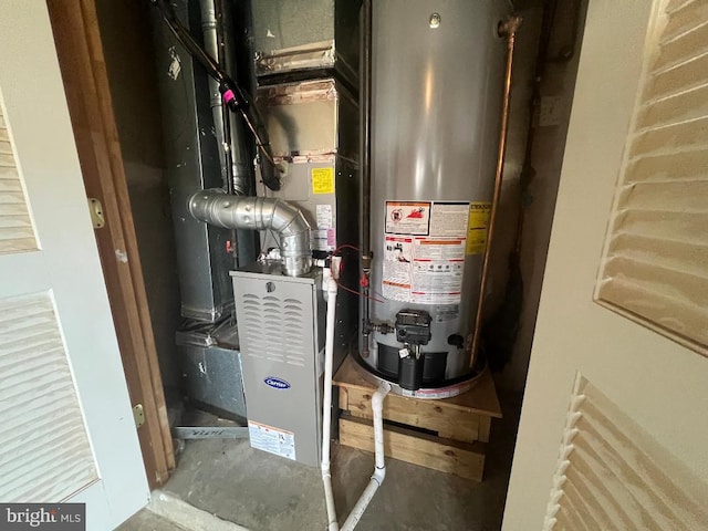 utility room featuring gas water heater and heating unit