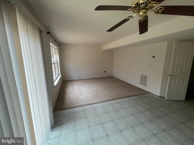 empty room with baseboards, visible vents, and tile patterned floors