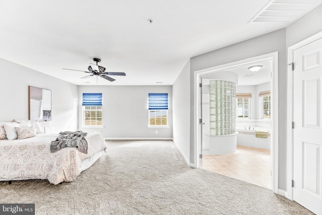 bedroom with ensuite bathroom, multiple windows, carpet flooring, and visible vents