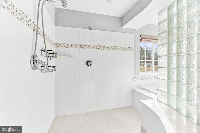 full bath featuring tile patterned flooring and a tile shower