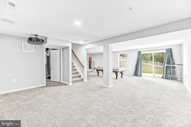 basement with stairway, carpet, visible vents, and baseboards