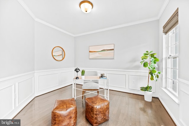 office area featuring a wainscoted wall, crown molding, and wood finished floors