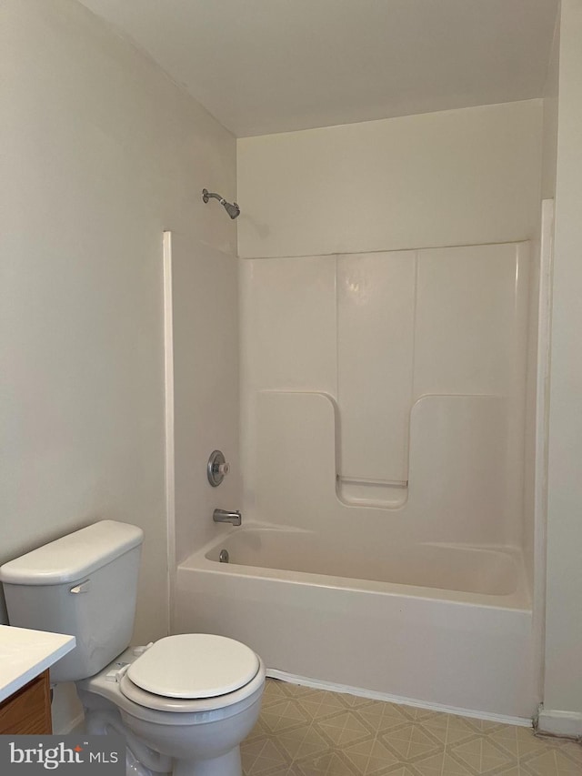 bathroom featuring toilet, tile patterned floors, shower / washtub combination, and vanity