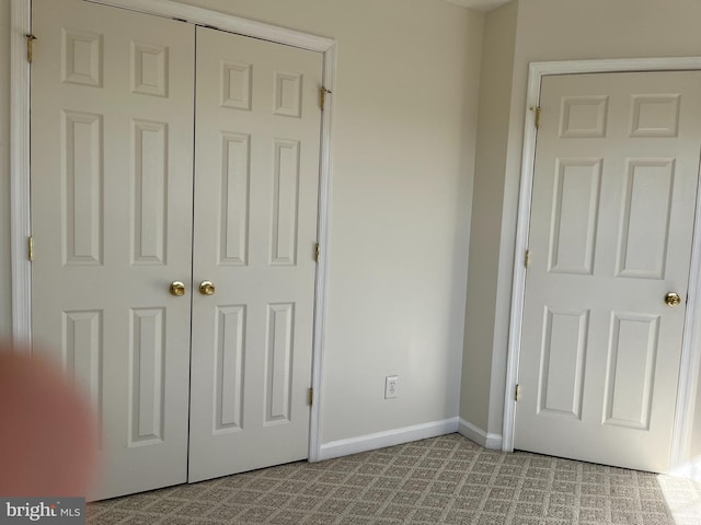 unfurnished bedroom with carpet flooring and baseboards