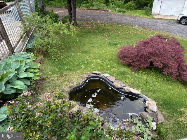view of yard with a small pond