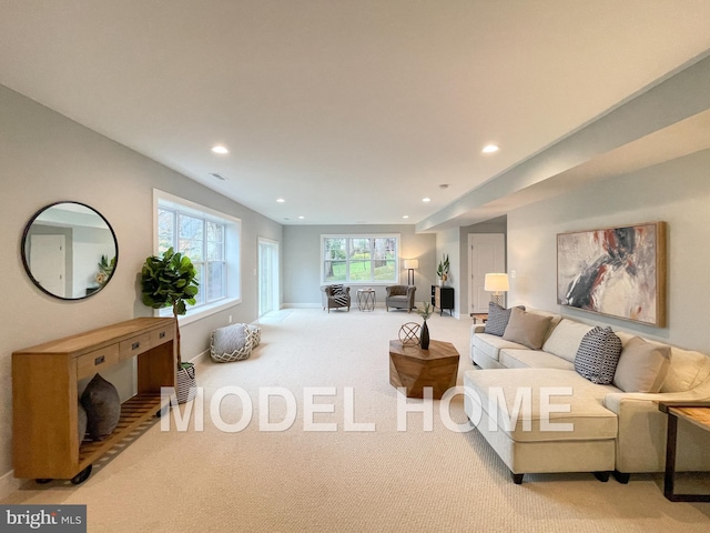 carpeted living room with baseboards, visible vents, and recessed lighting