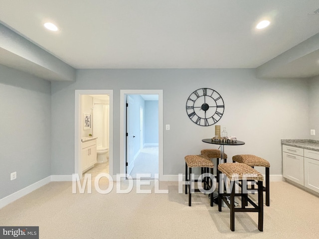 dining space with recessed lighting, baseboards, and light colored carpet