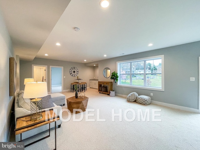 living area with carpet, baseboards, and recessed lighting