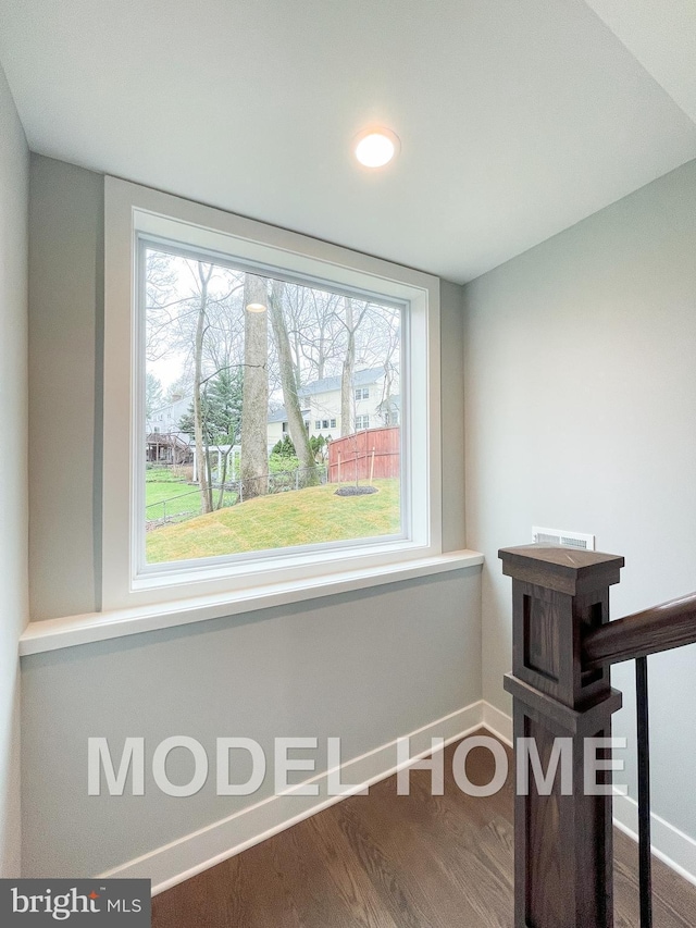 interior space with baseboards and wood finished floors