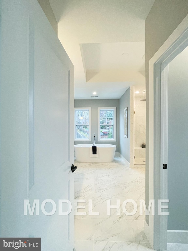 hall featuring marble finish floor and baseboards