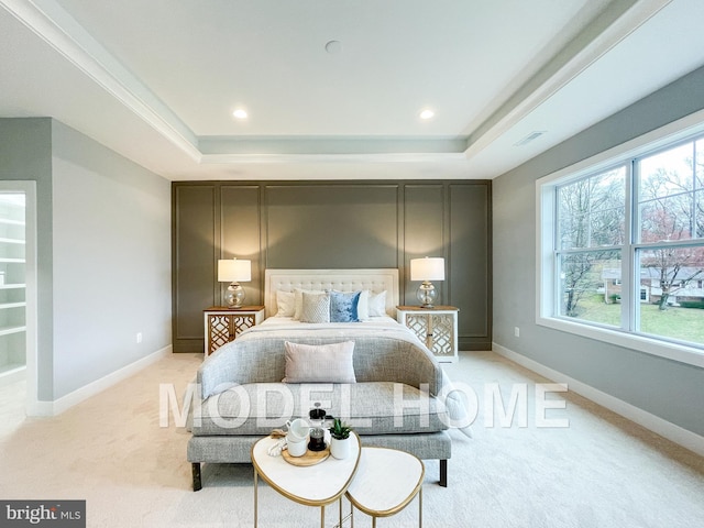 bedroom featuring recessed lighting, light carpet, visible vents, baseboards, and a raised ceiling