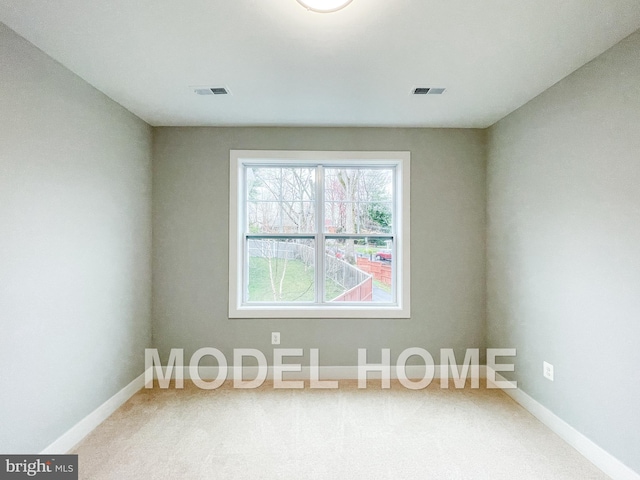 empty room featuring visible vents and baseboards