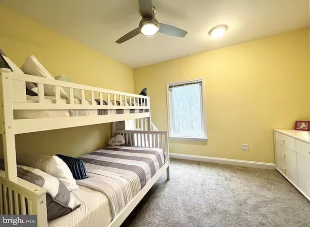 carpeted bedroom featuring ceiling fan and baseboards