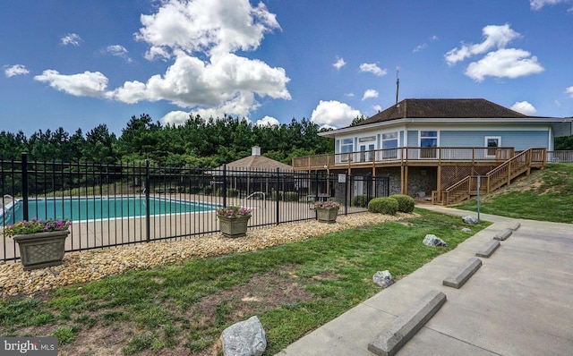 view of swimming pool featuring a fenced in pool, a yard, fence, a deck, and stairs