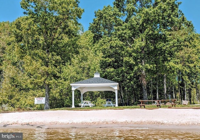 surrounding community featuring a gazebo and a water view