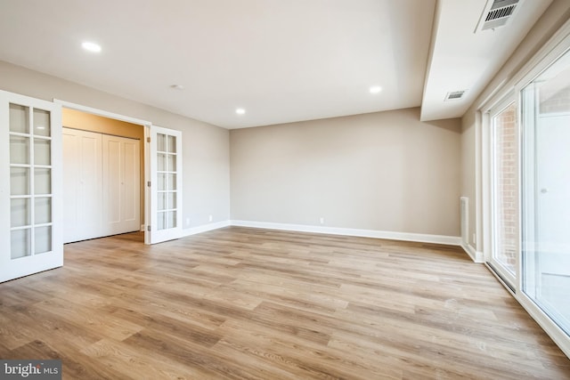 interior space with light wood finished floors, visible vents, and french doors