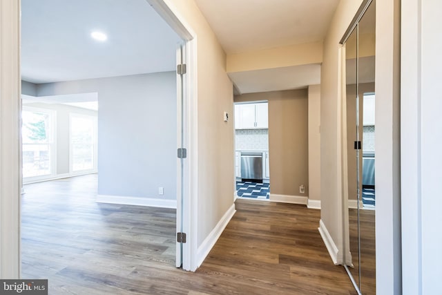 hall featuring baseboards and dark wood finished floors