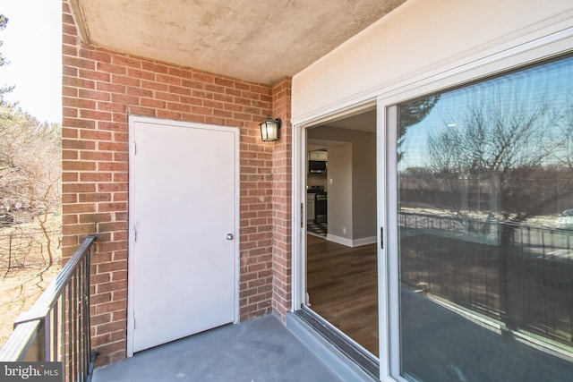 entrance to property with brick siding