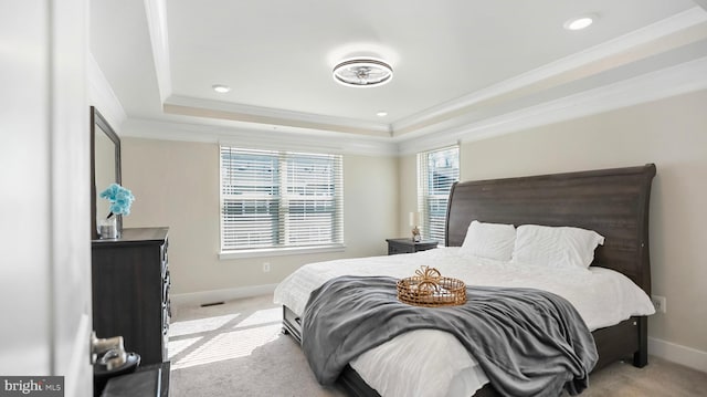 bedroom with light carpet, baseboards, a raised ceiling, and ornamental molding