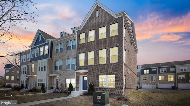 townhome / multi-family property with brick siding