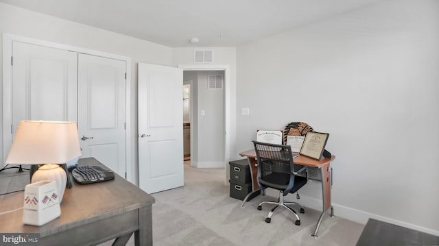 office area featuring light carpet, visible vents, and baseboards