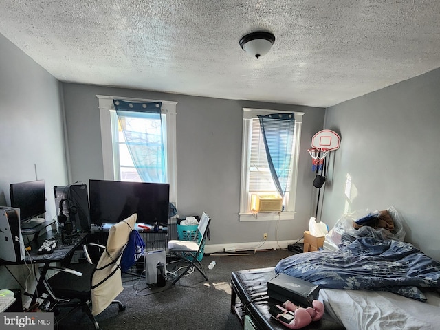 bedroom featuring a textured ceiling, baseboards, cooling unit, and carpet flooring