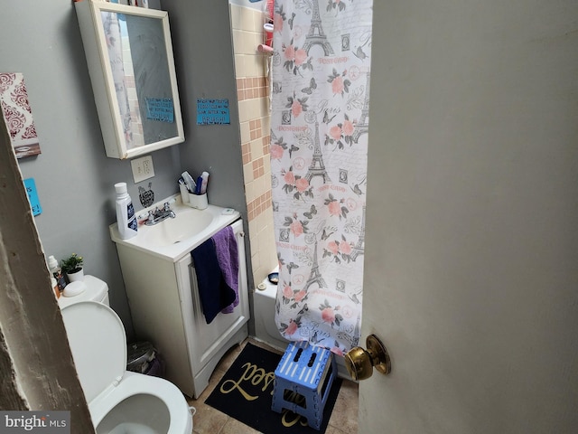 bathroom featuring toilet, shower / bath combo with shower curtain, and vanity