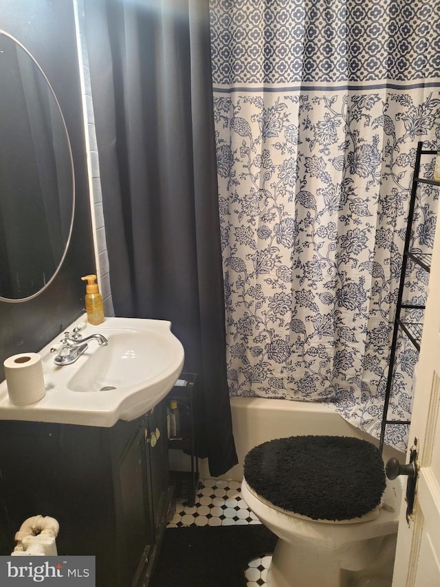 bathroom with curtained shower, toilet, vanity, and tile patterned flooring