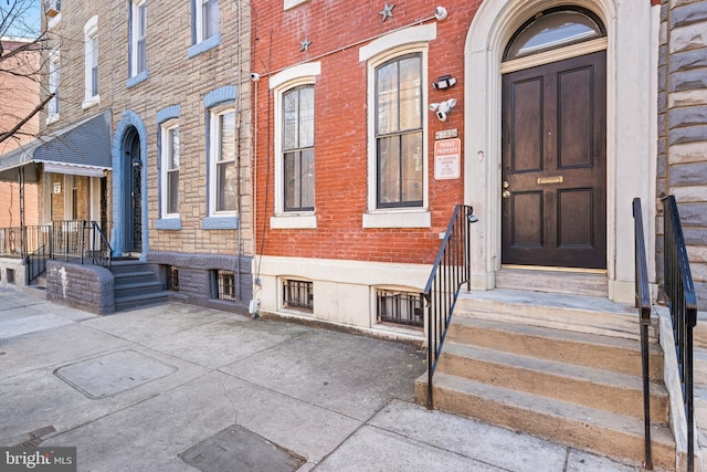 view of exterior entry with brick siding