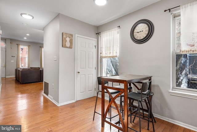 dining area with light wood-style floors, recessed lighting, visible vents, and baseboards