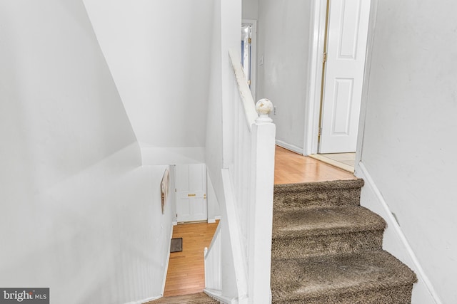 stairs featuring baseboards and wood finished floors