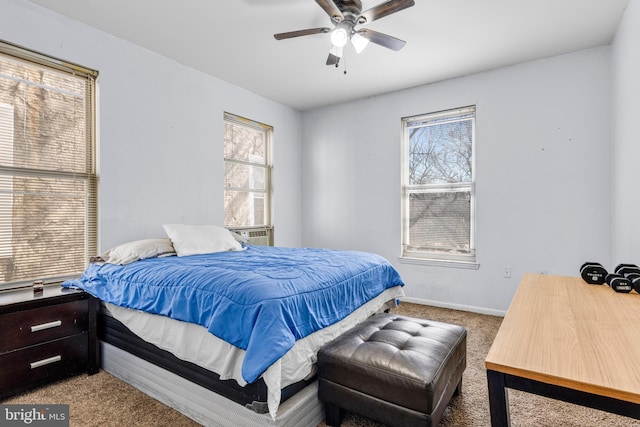 carpeted bedroom with baseboards and a ceiling fan