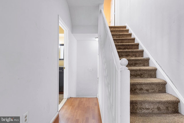 staircase with wood finished floors