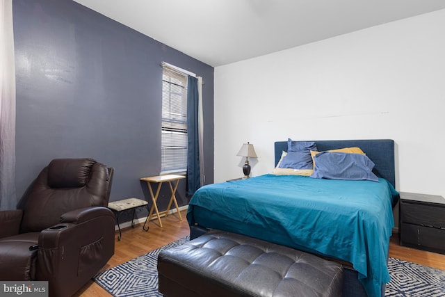 bedroom featuring baseboards and wood finished floors